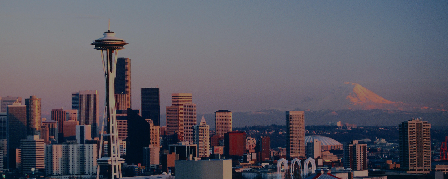 UK business travel Seattle — downtown skyline and business districts Seattle skyline and Mount Rainier representing UK business travel Seattle guide